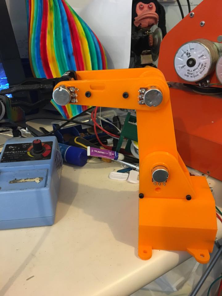Printed robot arm puppet controller on the bench.